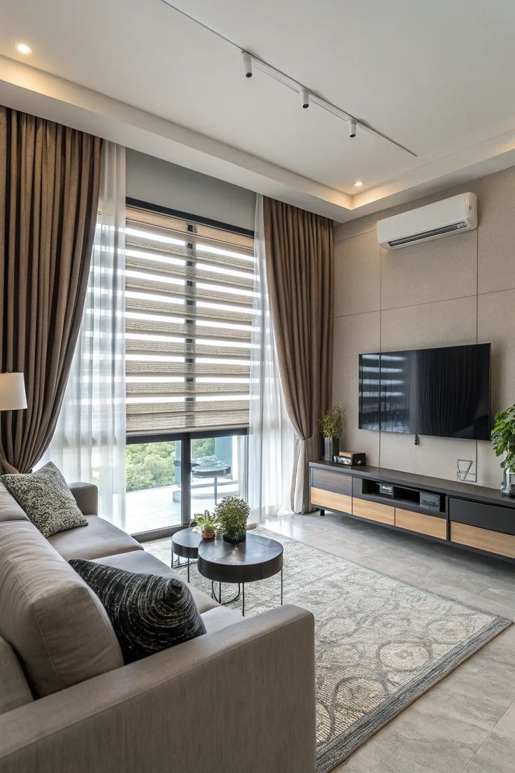 Houseway custom curtains and zebra blinds installation in a modern living room in Hyderabad, featuring layered sheer curtains and textured drapery.