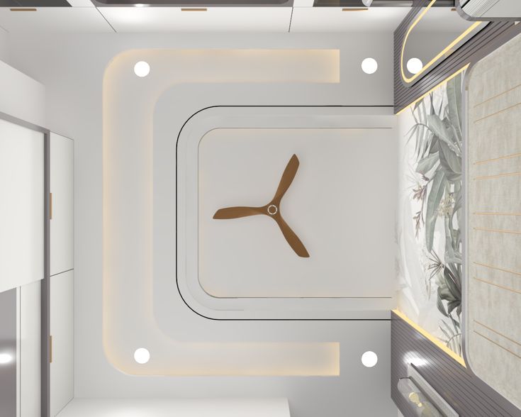 Modern false ceiling design with geometric cove lighting, recessed spotlights, and a sleek wooden three-blade ceiling fan in a luxury bedroom in Hyderabad.