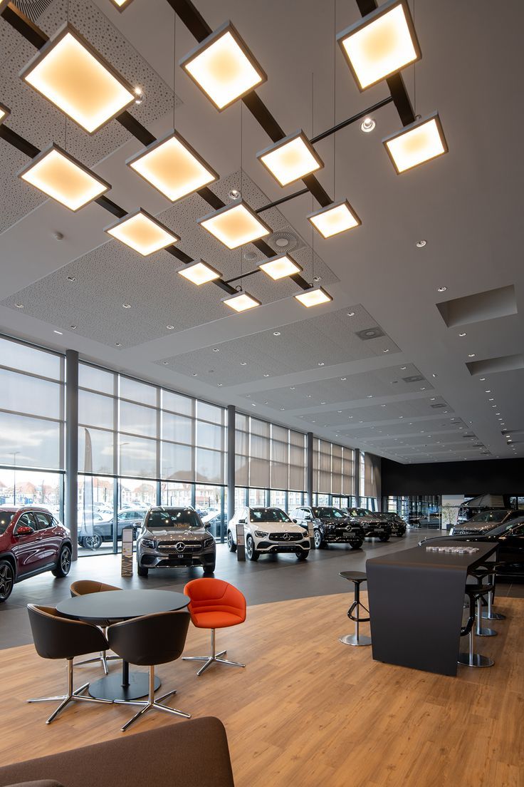 Houseway professional automobile showroom interior design and commercial fit-out services in Hyderabad, featuring expansive glass facades, modern pendant lighting, and customer consultation zones.